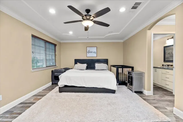 a bathroom with a granite countertop sink a toilet a shower and a mirror