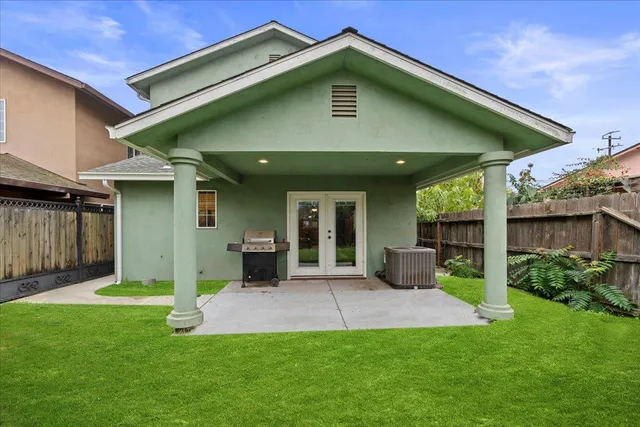 an aerial view of a house with a garden and a car parked