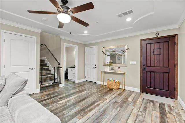 a living room with furniture a flat screen tv and a view of kitchen