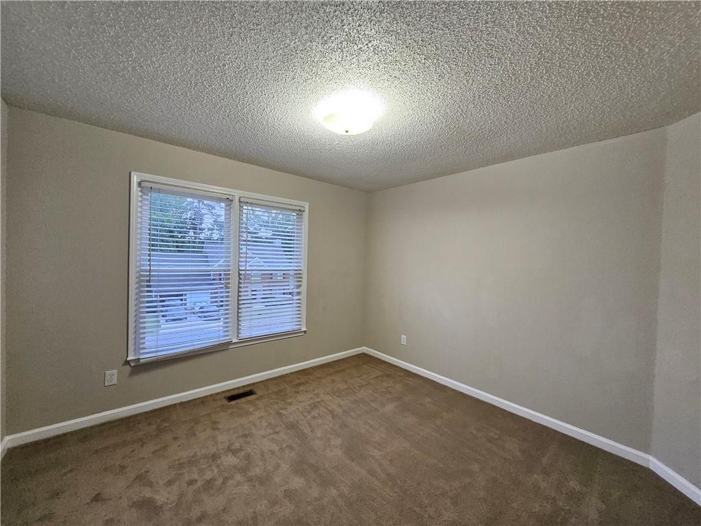 144 Hunters Trace Dallas, GA 30157 - Photo 15 of 34 an empty room with windows