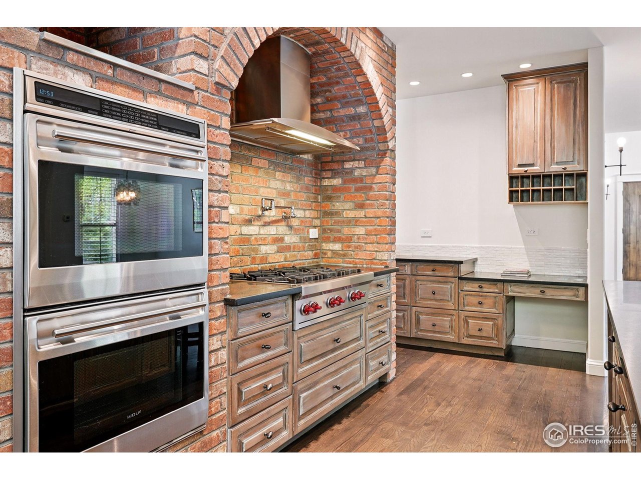 3219 7th Street Boulder, CO 80304 - Photo 11 of 34 a kitchen with granite countertop a stove oven and cabinets