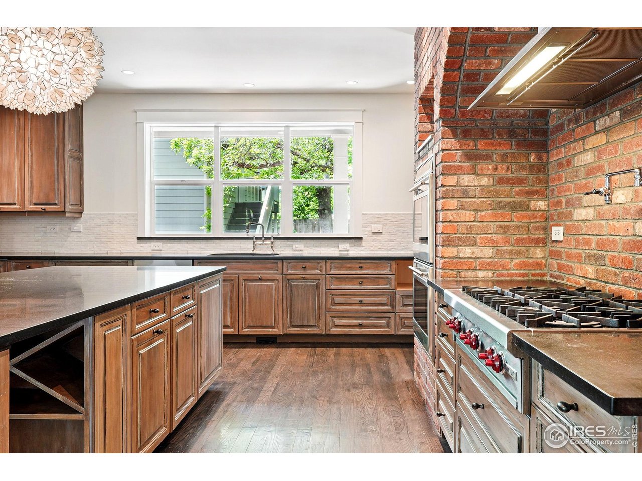 3219 7th Street Boulder, CO 80304 - Photo 12 of 34 a kitchen with a stove a sink and a wooden cabinets
