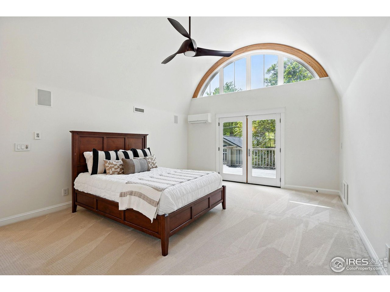 3219 7th Street Boulder, CO 80304 - Photo 22 of 34 a bed sitting in a bedroom next to a window