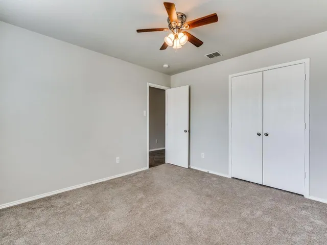 a view of a livingroom with a window and a ceiling fan