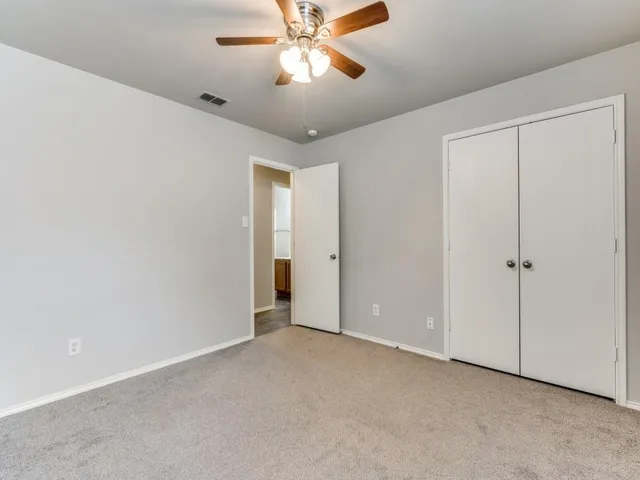 a view of a yard with a fence and trees
