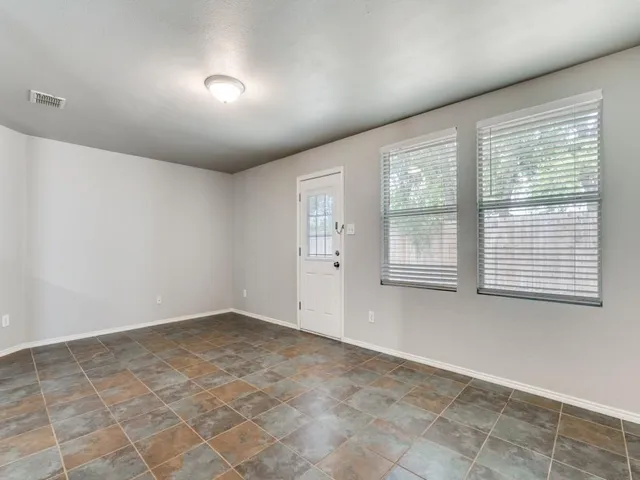 an empty room with fan and a ceiling fan
