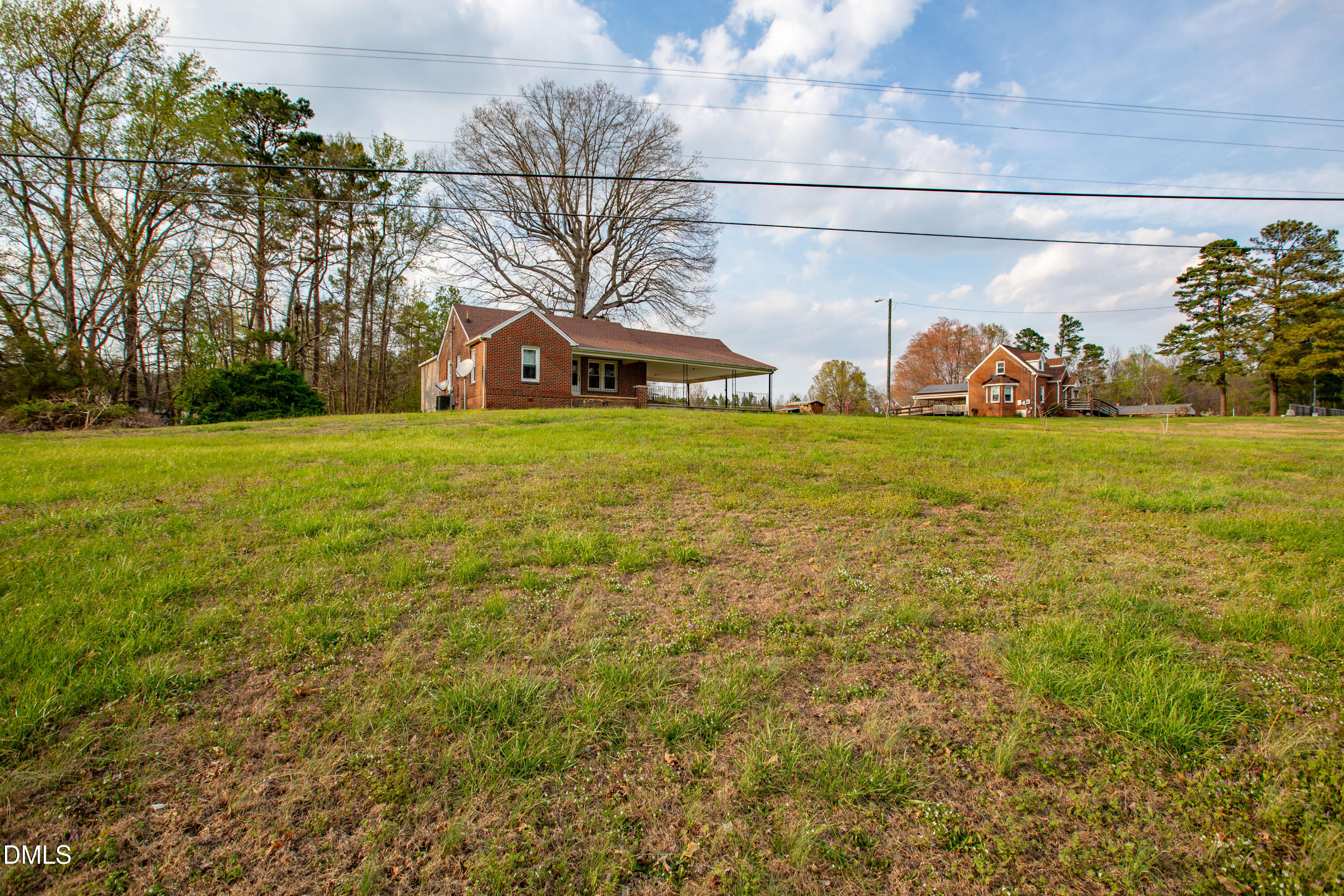 4295 Virgilina Road Roxboro, NC 27574 - Photo 45 of 46 a front view of a house with a yard and garage