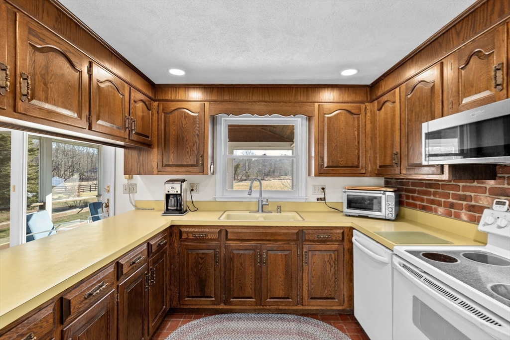 131 Free Street Hingham, MA 02043 - Photo 16 of 39 a kitchen that has a sink and a stove in it