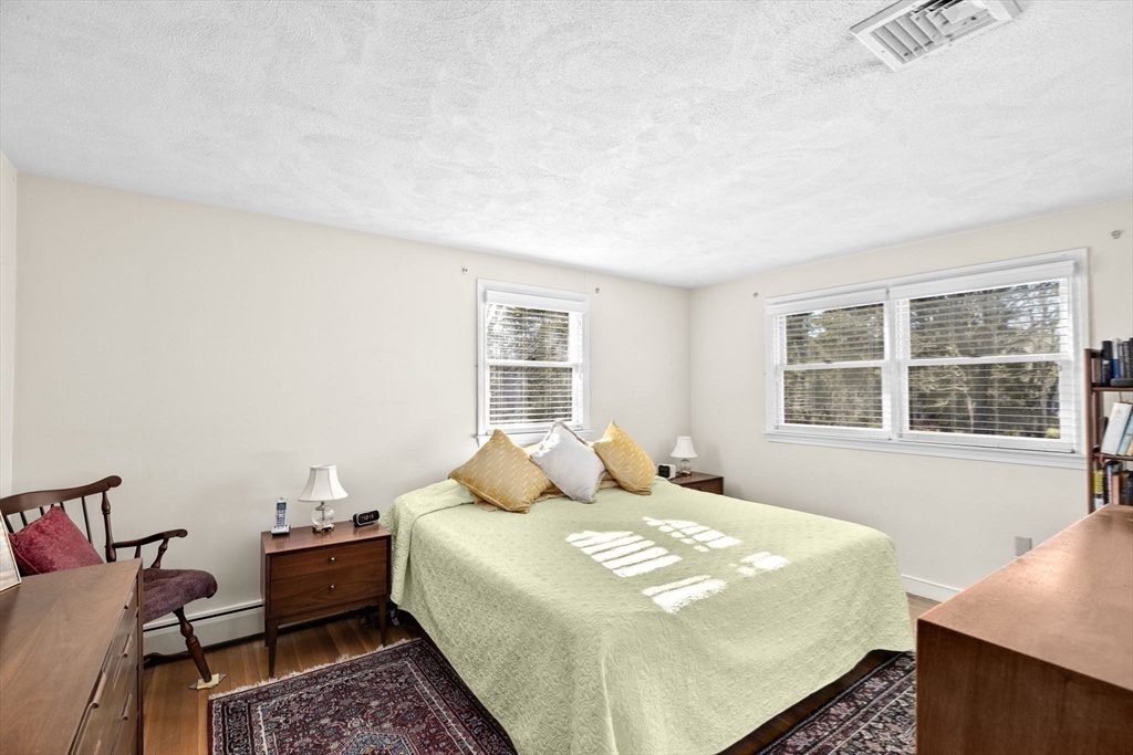 131 Free Street Hingham, MA 02043 - Photo 17 of 39 a bedroom with a bed and wooden floor