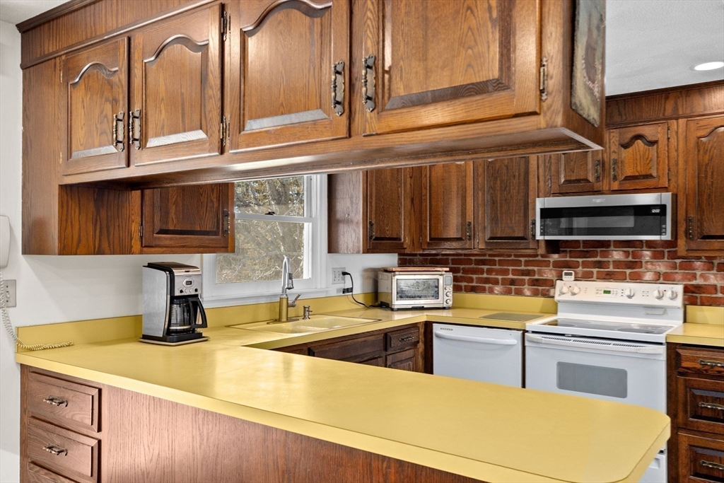 131 Free Street Hingham, MA 02043 - Photo 22 of 39 a kitchen with stainless steel appliances a sink and cabinets