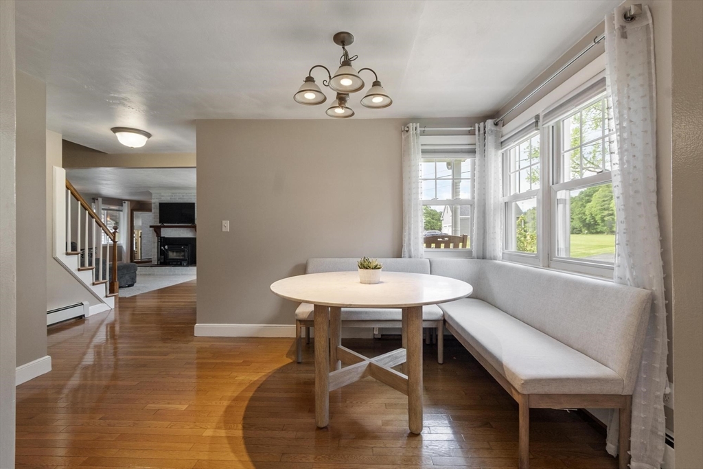 167 Gates Pond Road Berlin, MA 01503 - Photo 11 of 32 a view of a dining room with furniture window and wooden floor