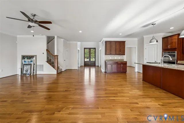 a view of a living room kitchen and a wooden floor