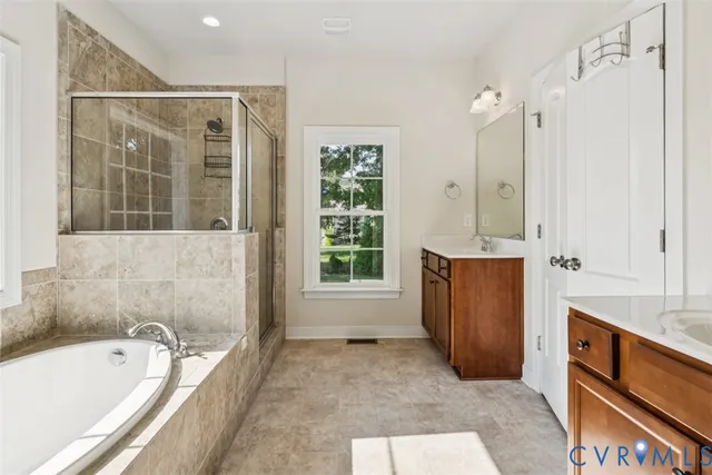 a bathroom with a tub sink and mirror