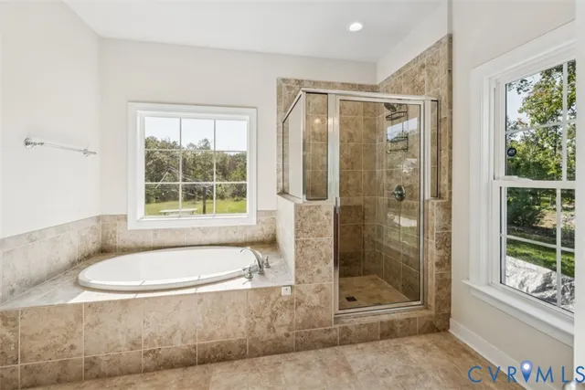 a bathroom with a tub shower and sink