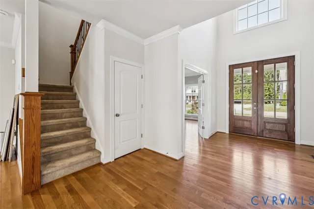 a view of an entryway with wooden floor and door