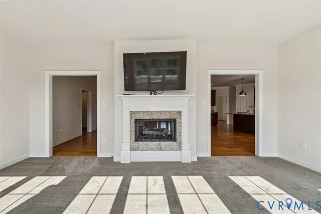 a living room with a fireplace and a rug