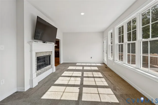 a view of a livingroom with an empty space and a fireplace