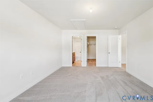 an empty room with closet and mirror