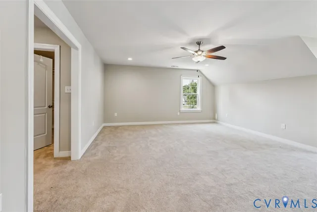 an empty room with windows and ceiling fan