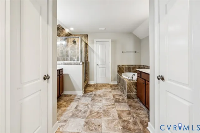 a bathroom with a granite countertop shower and a sink