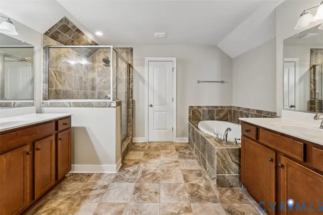 a spacious bathroom with a granite countertop sink a mirror and a bathtub
