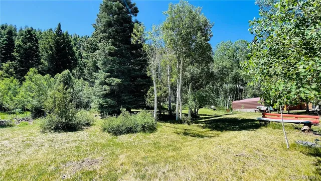 an aerial view of a house with backyard space and balcony