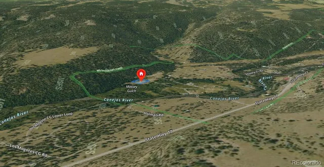 an aerial view of a houses with large trees