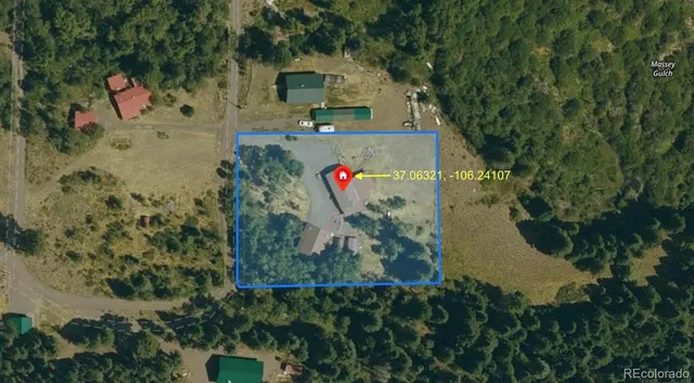 an aerial view of a house with a yard