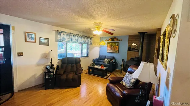 a living room with furniture fireplace and a window