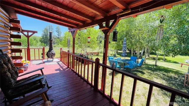 a view of a porch with wooden floor outdoor seating