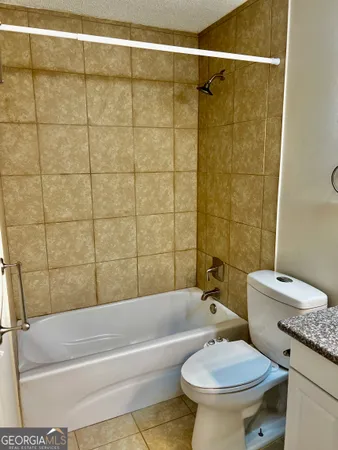 a spacious bathroom with a granite countertop sink a mirror and a vanity