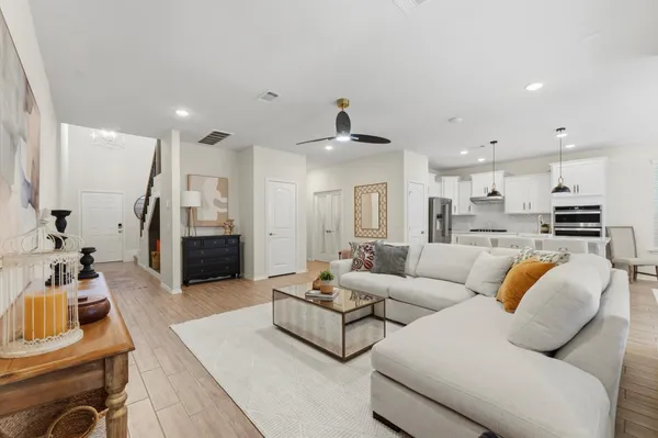 a living room with furniture and kitchen view