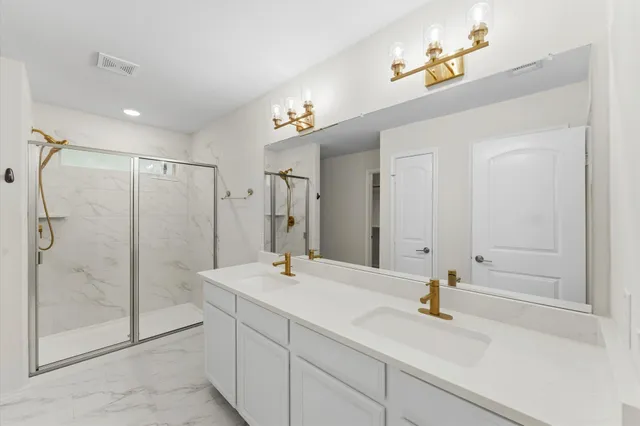 a bathroom with a shower sink and mirror