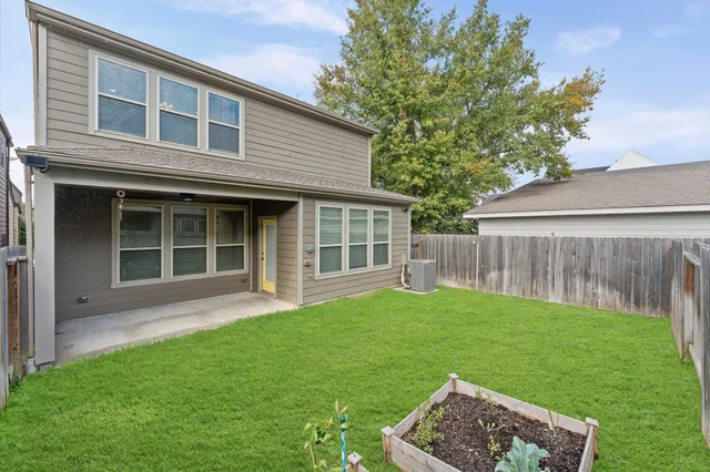 a front view of a house with a garden and yard