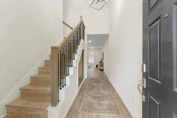 a view of entryway and gallery with wooden floor