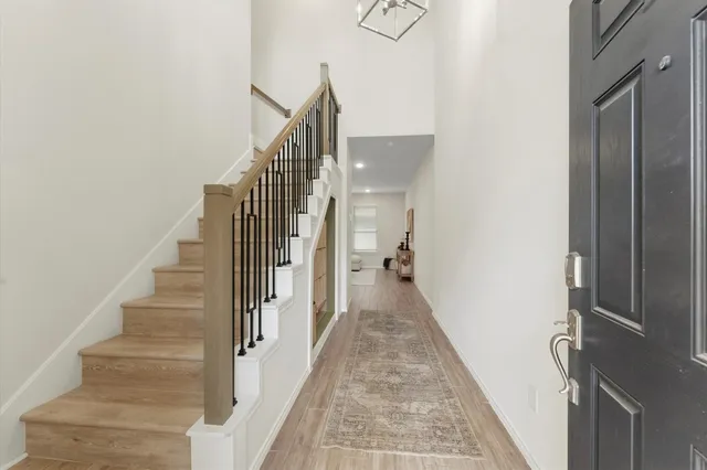 a view of entryway and gallery with wooden floor
