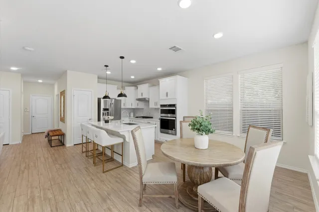 a view of a dining room with furniture and wooden floor