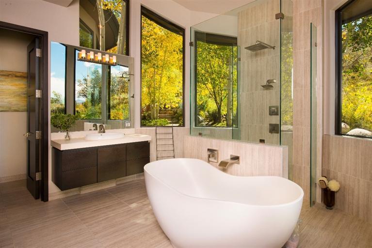 184 Arrowhead Drive Edwards, CO 81632 - Photo 14 of 23 a bathroom with a white tub a sink and a large window