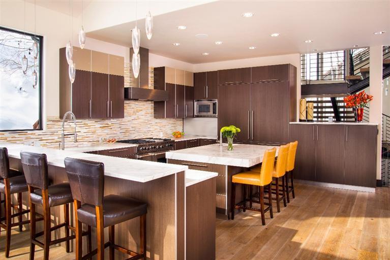 184 Arrowhead Drive Edwards, CO 81632 - Photo 8 of 23 a kitchen with stainless steel appliances kitchen island granite countertop a dining table chairs and a refrigerator