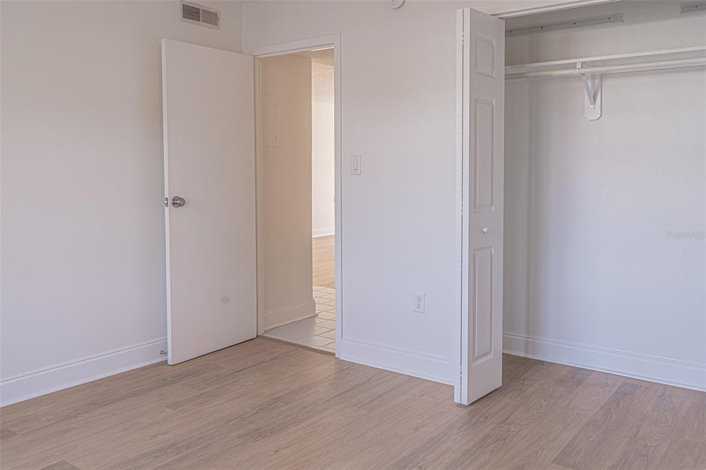 363 South McMullen Booth Road, Unit 107 Clearwater, FL 33759 - Photo 13 of 21 a view of an empty room with wooden floor