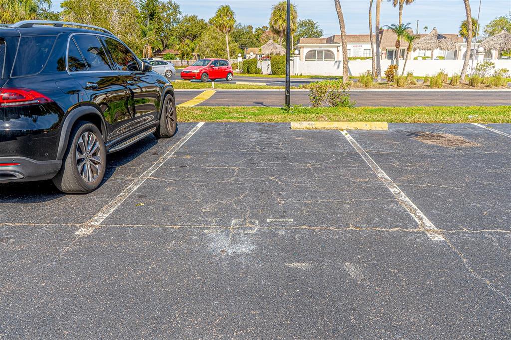363 South McMullen Booth Road, Unit 107 Clearwater, FL 33759 - Photo 21 of 21 a front view of a house with a garden and parking space