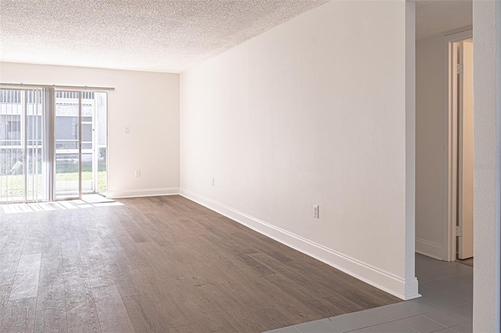 363 South McMullen Booth Road, Unit 107 Clearwater, FL 33759 - Photo 4 of 21 an empty room with wooden floor and windows