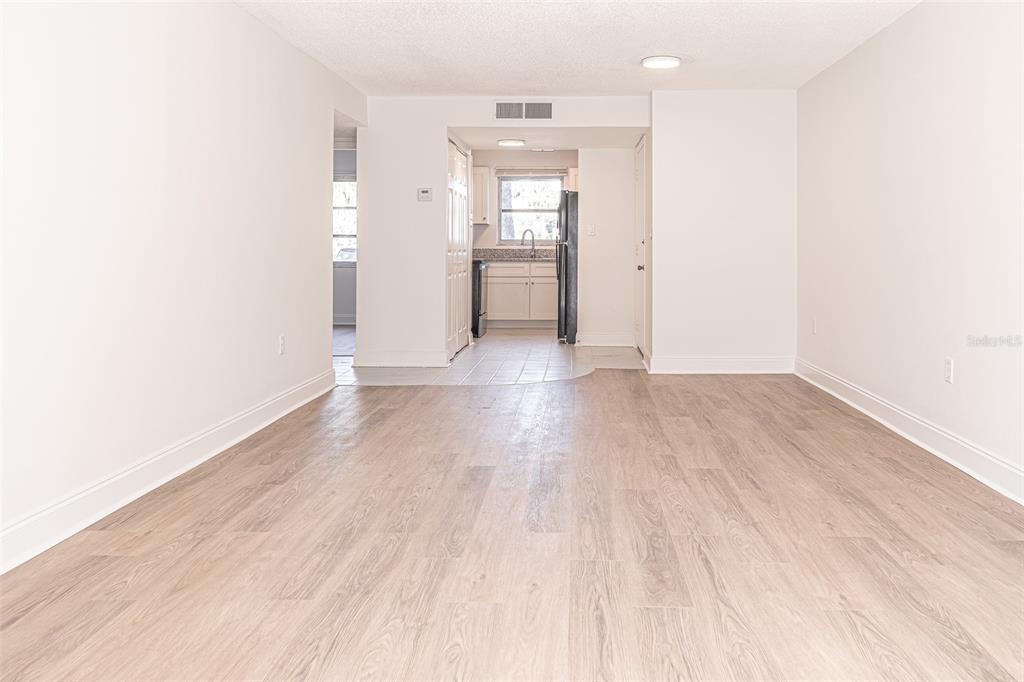 363 South McMullen Booth Road, Unit 107 Clearwater, FL 33759 - Photo 5 of 21 a view of an empty room with window and wooden floor
