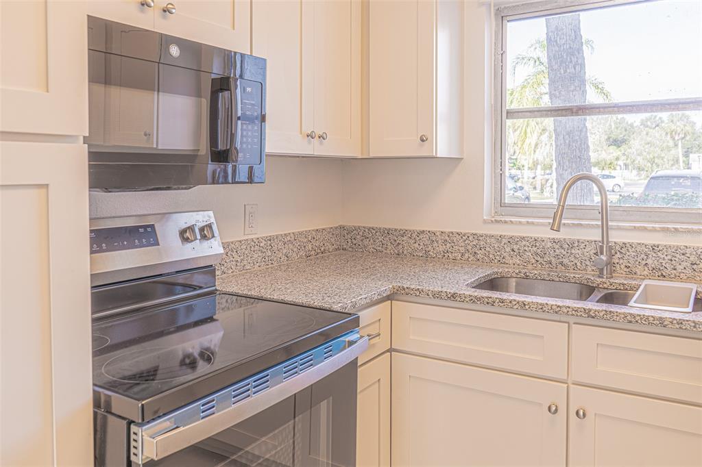 363 South McMullen Booth Road, Unit 107 Clearwater, FL 33759 - Photo 7 of 21 a kitchen with a sink cabinets and window