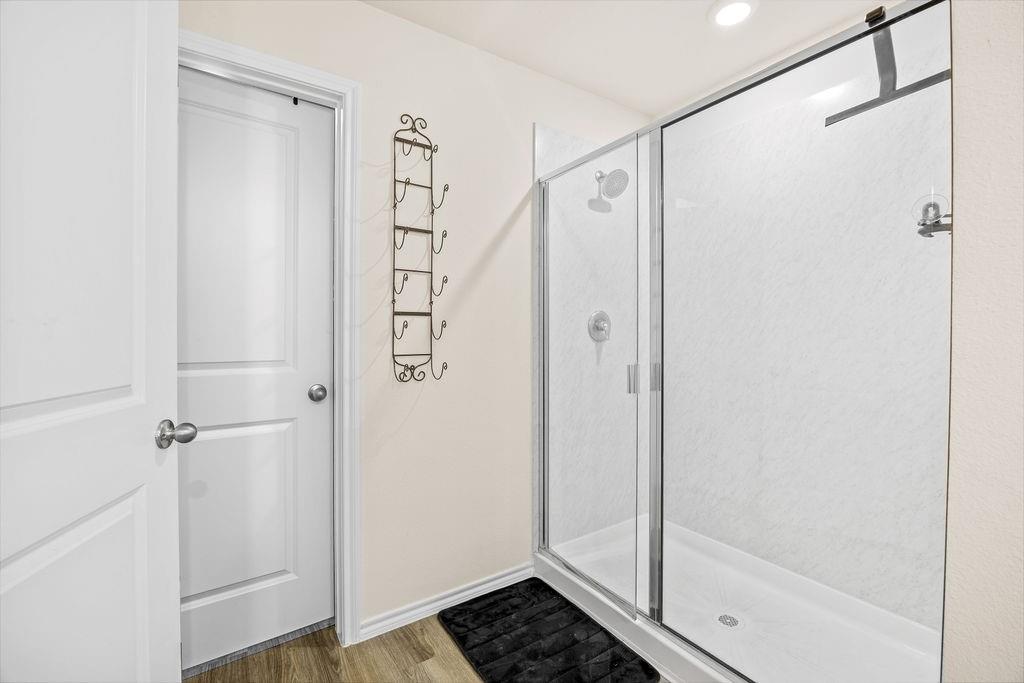 822 Ramble Road Lavon, TX 75166 - Photo 28 of 35 Walk-in shower featuring a sliding glass enclosure and white shower base