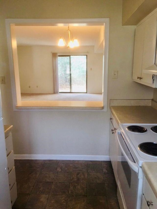 2102 Spring Forest Road, Unit 2102 Raleigh, NC 27615 - Photo 4 of 6 a kitchen with a sink cabinets and a window