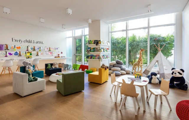 a living room with furniture large window and a table