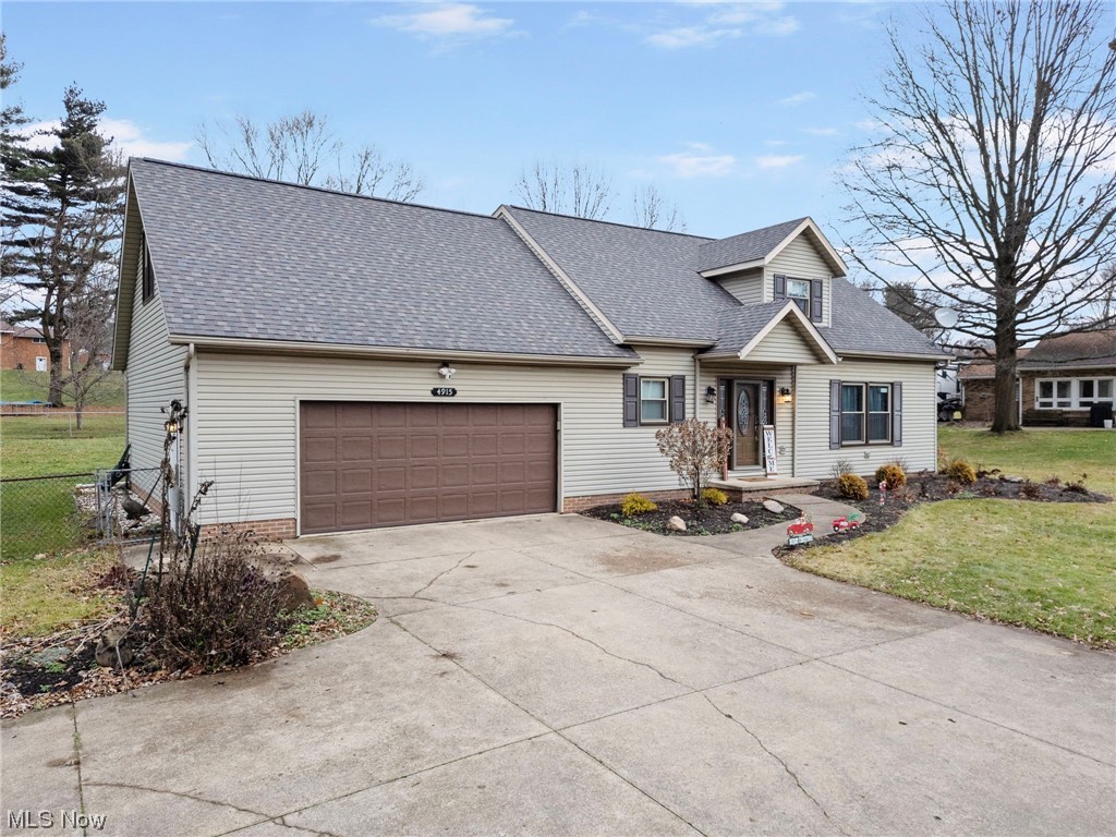 4915 Monticello Street Northwest Canton, OH 44708 - Photo 2 of 31 View of front of house featuring a garage and a front lawn
