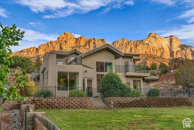 101 Chuckwalla Lane Springdale, UT 84767 - Photo 1 of 51 Back of house featuring stucco siding, a balcony, and a mountain view
