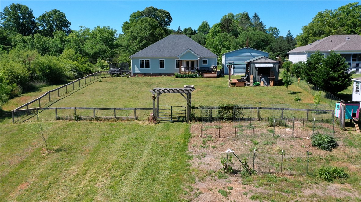 696 Mt Olivet Road Six Mile, SC 29682 - Photo 29 of 35 Expansive green backyard, featuring a cozy home and detached outbuilding, ideal for tranquil living.